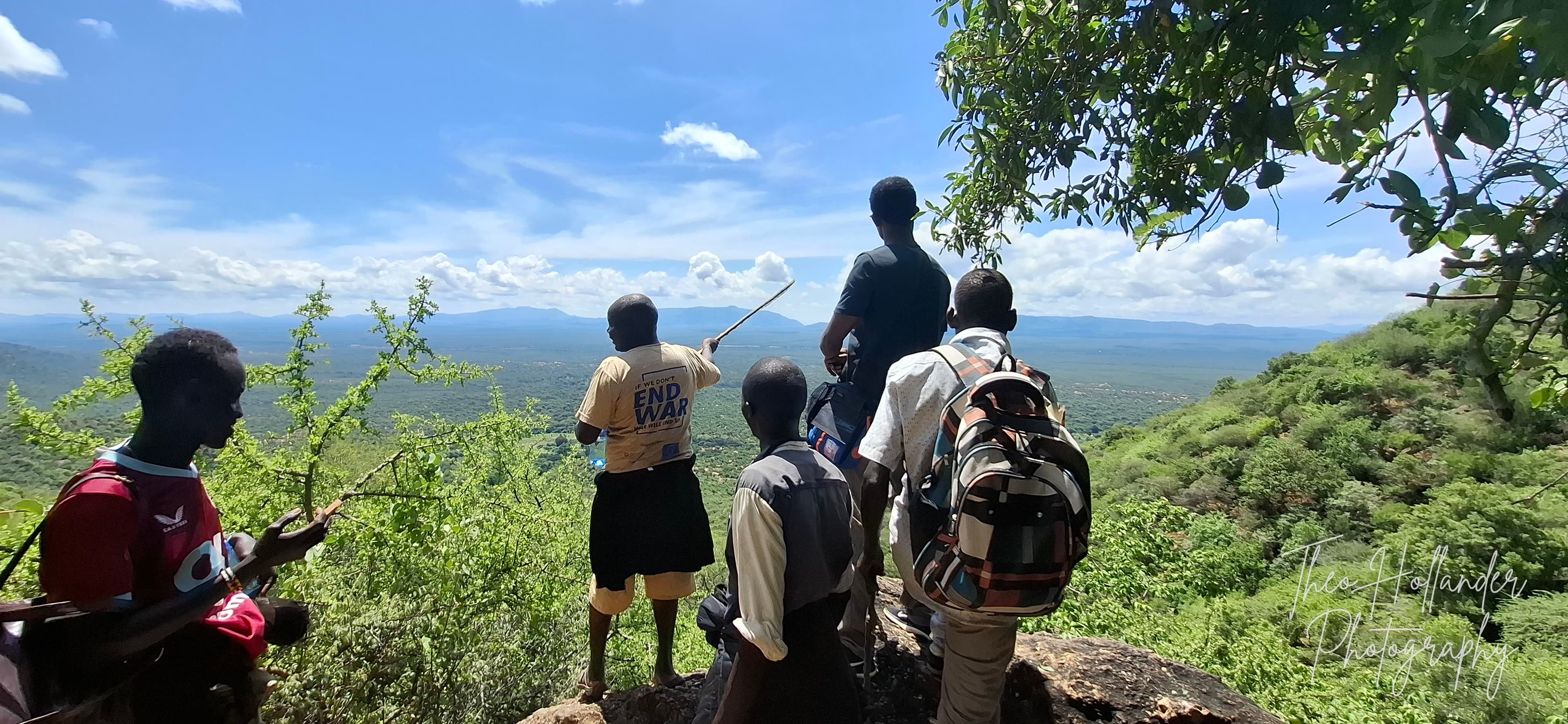 Local guides taking in the view from a mountain summit